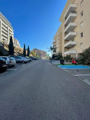 an empty street with cars parked on the side of a building at Bagnu di sole - sur la route des îles sanguinaires adorable T2 vue mer in Ajaccio