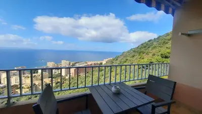 a balcony with a table and chairs and the ocean at Splendide vue dans ce studio ! in Ajaccio