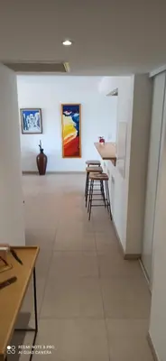 a room with chairs and paintings on the wall at ARCA C14 in Porto-Vecchio