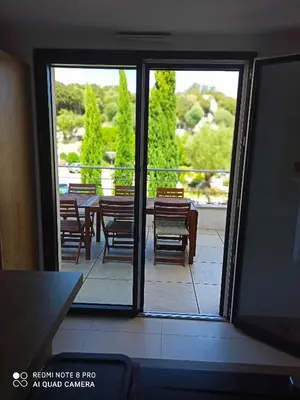 a view of a patio with a table and chairs at ARCA C14 in Porto-Vecchio