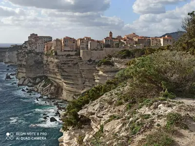 a city on top of a cliff next to the ocean at ARCA C14 in Porto-Vecchio