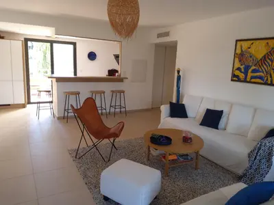 a living room with a white couch and a table at ARCA C14 in Porto-Vecchio