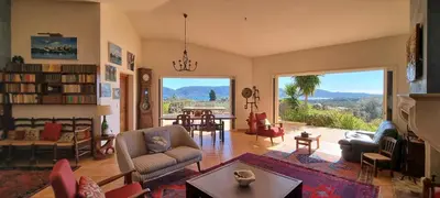 a living room with a view of the mountains at CASA SOPRANA - HAUT DE VILLA indépendant avec piscine et jardin privés - Independant TOP OF VILLA with private pool and garden in Porto-Vecchio