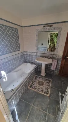 a bathroom with a tub and a sink at CASA SOPRANA - HAUT DE VILLA indépendant avec piscine et jardin privés - Independant TOP OF VILLA with private pool and garden in Porto-Vecchio
