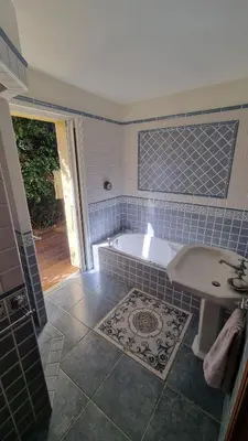 a blue tiled bathroom with a tub and a sink at CASA SOPRANA - HAUT DE VILLA indépendant avec piscine et jardin privés - Independant TOP OF VILLA with private pool and garden in Porto-Vecchio