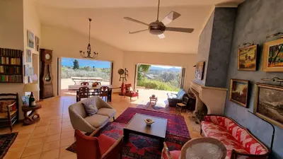 a living room with a couch and a ceiling fan at CASA SOPRANA - HAUT DE VILLA indépendant avec piscine et jardin privés - Independant TOP OF VILLA with private pool and garden in Porto-Vecchio