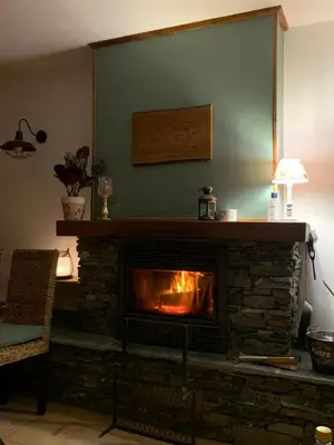 a fireplace in a living room with a fire place at A Casetta d’Hélène et Jeanette in Omessa