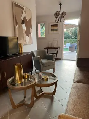 a living room with a couch and a tv at Maison Le Prunier avec piscine - Domaine E Case Di Cuttoli in Cuttoli-Corticchiato
