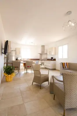 a large living room with a table and chairs at Alzitone in Ghisonaccia