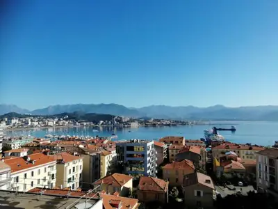 a city with buildings and a body of water at Centre ville avec vue magnifique sur le golfe d'Ajaccio; parking privé. in Ajaccio