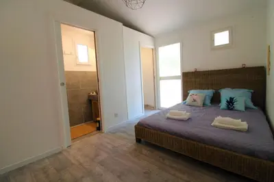 a bedroom with a bed with two towels on it at Rogliano in Porto-Vecchio