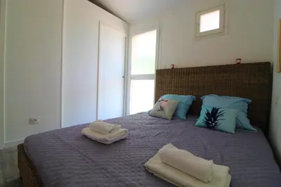 a bedroom with a bed with towels on it at Rogliano in Porto-Vecchio