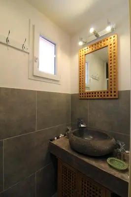 a bathroom with a sink and a mirror at Rogliano in Porto-Vecchio