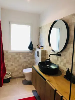 a bathroom with a black sink and a mirror at Chambre à Louer sur bonifacio in Bonifacio