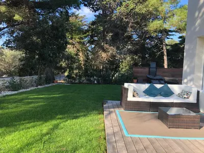 a backyard with a couch and a lawn at Chambre à Louer sur bonifacio in Bonifacio