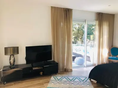 a bedroom with a flat screen tv and a bed at Chambre à Louer sur bonifacio in Bonifacio