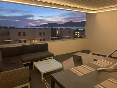 a living room with a couch and a table at Appartement T3 de standing, vue mer - Porticcio in Grosseto-Prugna
