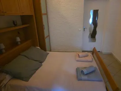 a bedroom with a bed with two towels on it at maisonnette à la campagne in San-Gavino-di-Carbini
