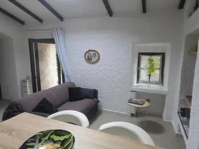 a living room with a purple couch and chairs at maisonnette à la campagne in San-Gavino-di-Carbini