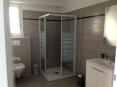 a bathroom with a shower with a toilet and a sink at apartment on the sea - Moriani beach in San-Nicolao