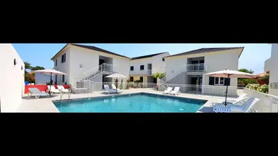 a large house with a lawn in front of it at T-2 air conditioning close to the sea - equipped beach - Santa Lucia di Moriani in San-Nicolao