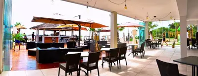 a restaurant with tables and chairs and umbrellas at Apartment next to the sea 4 peoples-WIFI-TV-Air Conditioning-Moriani Haute-Corse in San-Nicolao
