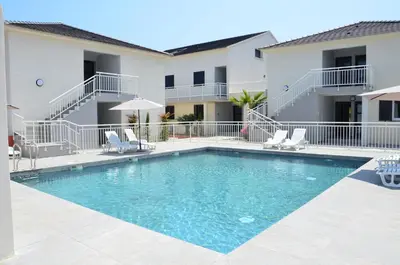 a swimming pool in front of a building at Apartment next to the sea 4 peoples-WIFI-TV-Air Conditioning-Moriani Haute-Corse in San-Nicolao