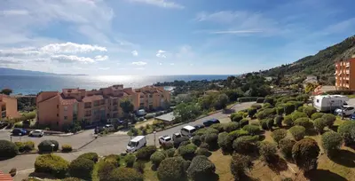 an aerial view of a town with cars parked in a parking lot at T1 vue mer bord de mer Ajaccio in Ajaccio
