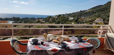 a table on a balcony with a view of the ocean at T1 vue mer bord de mer Ajaccio in Ajaccio