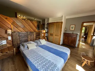 a bedroom with a large bed with a blue comforter at A CASA CANTUNNIERA in Pietroso