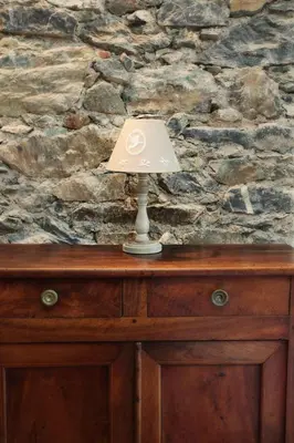 a lamp sitting on top of a wooden dresser at A CASA CANTUNNIERA in Pietroso