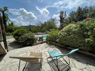 a patio with two chairs and a swimming pool at A CASA CANTUNNIERA in Pietroso