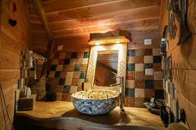 a bathroom with a sink and a mirror at La Cabane du Bandit in Pietroso