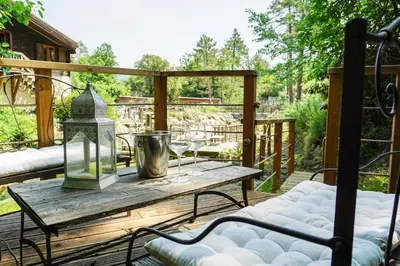 a wooden deck with a table and two chairs at La Cabane du Bandit in Pietroso