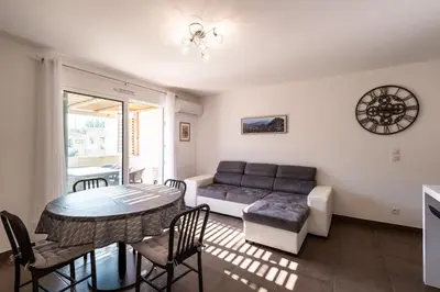 a living room with a couch and a table at Le Clos d'Oletta in Oletta