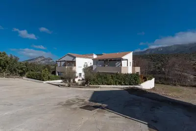 a house in the middle of a parking lot at Le Clos d'Oletta in Oletta