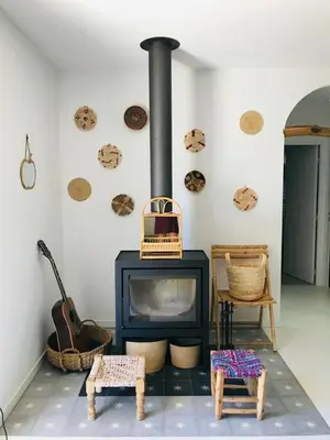 a living room with a stove with two chairs at Villa de standing, piscine chauffée,Balagne, Pietralba in Pietralba