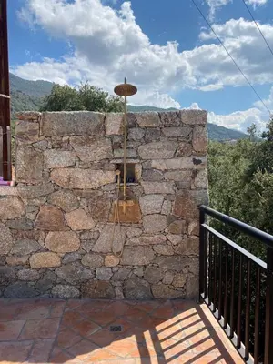 a stone wall with a lantern on a balcony at Villa de standing, piscine chauffée,Balagne, Pietralba in Pietralba