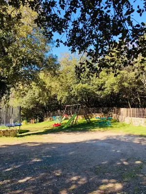a playground in a park with a swing at Villa de standing, piscine chauffée,Balagne, Pietralba in Pietralba