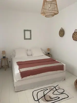 a bedroom with a bed with a rug on the floor at Villa de standing, piscine chauffée,Balagne, Pietralba in Pietralba