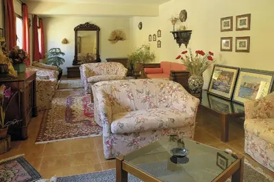 a living room with two couches and a table at Hôtel Aïtone in Evisa