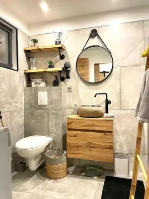 a bathroom with a toilet and a mirror at Mini villa chaleureuse avec vue mer imprenable in San-Nicolao