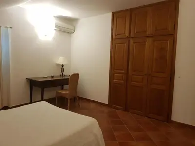 a bedroom with a desk and a bed and a table at Domaine de Valle in Sorbo-Ocagnano
