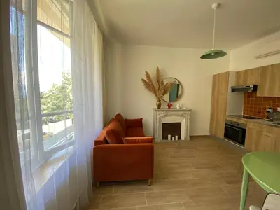 a living room with a couch and a fireplace at 2 pièces / neuf - Ajaccio centre - Place Miot / Albert 1er in Ajaccio