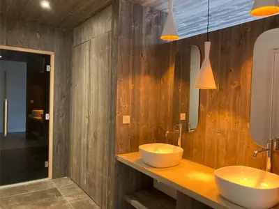 a wooden bathroom with two sinks and a mirror at Les Lofts de Sainte-Lucie-de-Porto-Vecchio in Sainte-Lucie de Porto-Vecchio