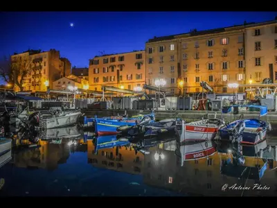 a group of boats docked in a marina at night at Cosystudio centre Ajaccio in Ajaccio