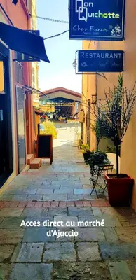 an empty street with a sign on a building at Cosystudio centre Ajaccio in Ajaccio