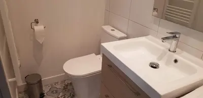 a white bathroom with a sink and a toilet at Cosystudio centre Ajaccio in Ajaccio