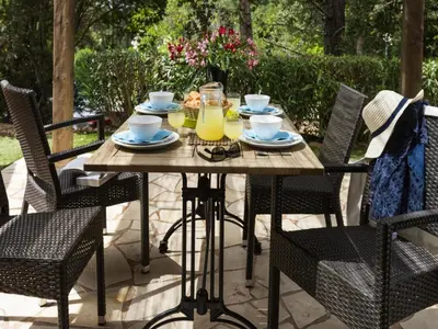 a wooden table with plates and drinks on a patio at Apartment in Corsica near Sandy Beach in Favone