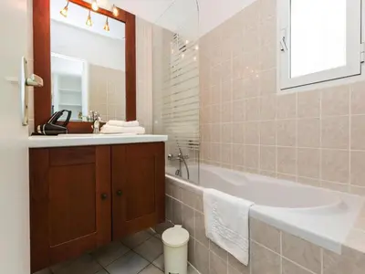 a bathroom with a tub and a sink at Apartment in Corsica near Sandy Beach in Favone